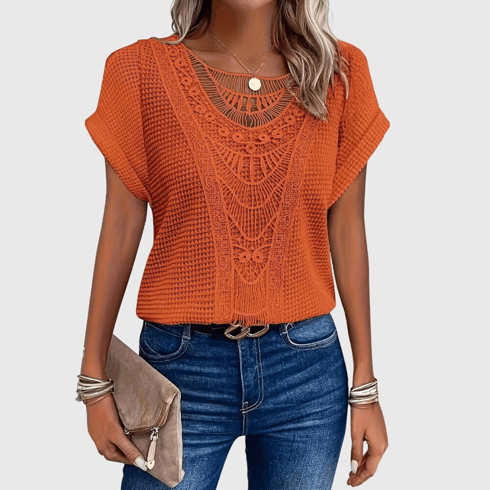 Isabel y Miguel Madrid Perla™ Ibiza style elegant blouse with flowing fabric and intricate details, perfect for stylish summer wear.