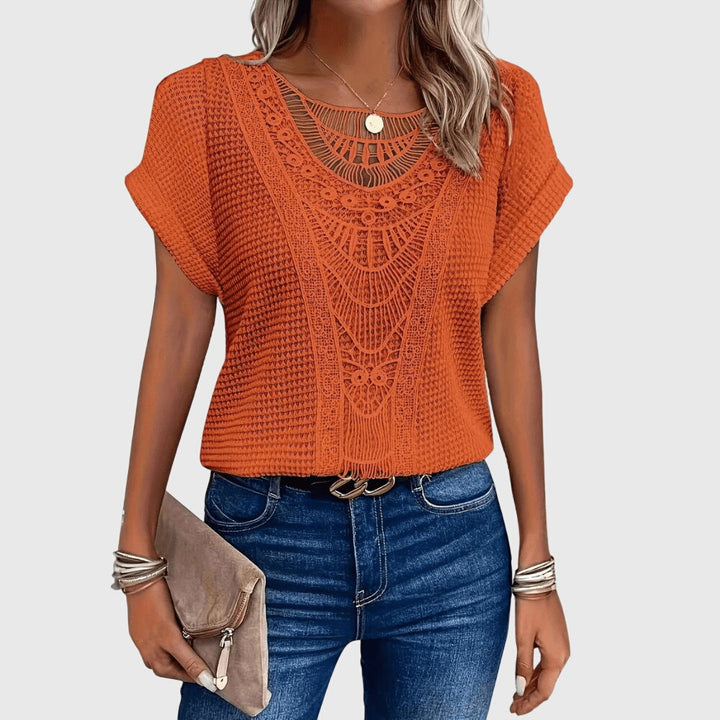 Isabel y Miguel Madrid Perla™ Ibiza style elegant blouse with flowing fabric and intricate details, perfect for stylish summer wear.