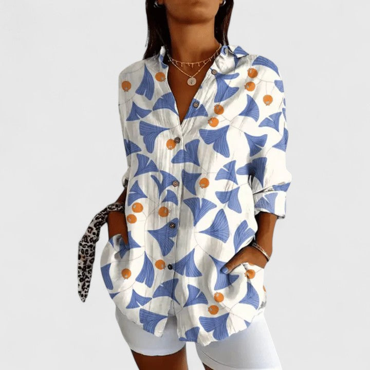 Isabel y Miguel Madrid Katarine floral blouse with a feminine design, featuring colorful floral patterns and lightweight fabric.