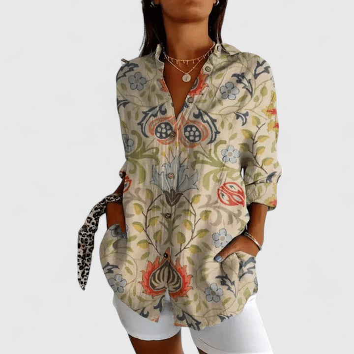 Elegant floral blouse from Isabel y Miguel Madrid featuring a lightweight fabric and a stylish, feminine design.