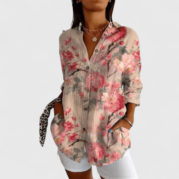 Isabel y Miguel Madrid Katarine floral blouse with elegant design, featuring colorful floral patterns on lightweight fabric.