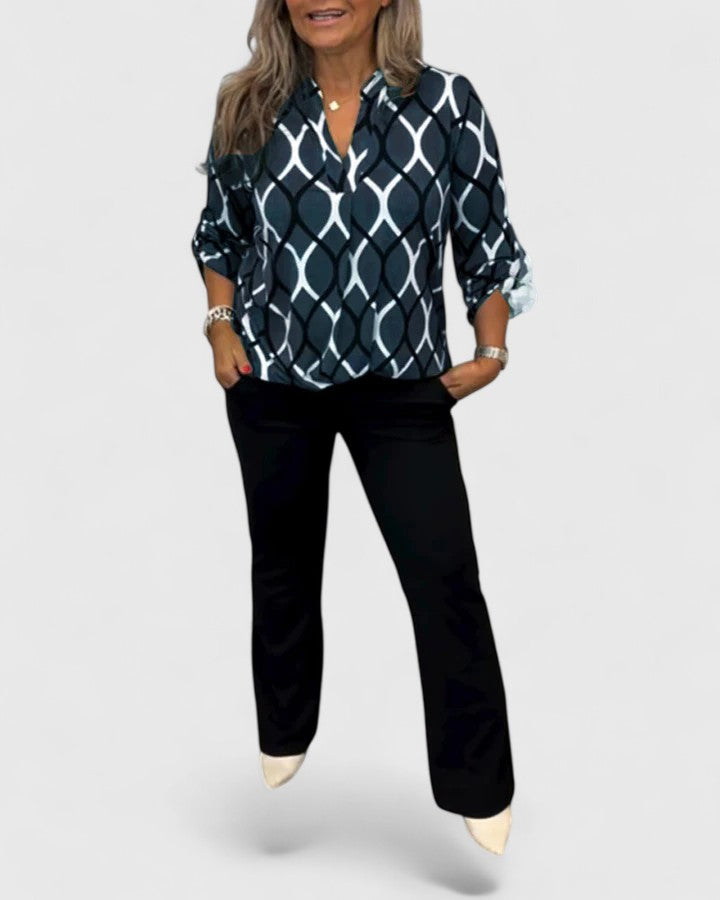 Elegant Isabel y Miguel Madrid Ella blouse featuring stylish fabric and tailored fit, shown on a model in this fashion image.
