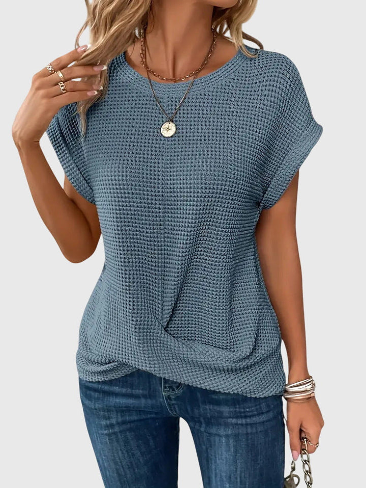 Isabel y Miguel Madrid Isa™ chic blouse with round neckline, featuring elegant fabric and stylish design on a neutral background.