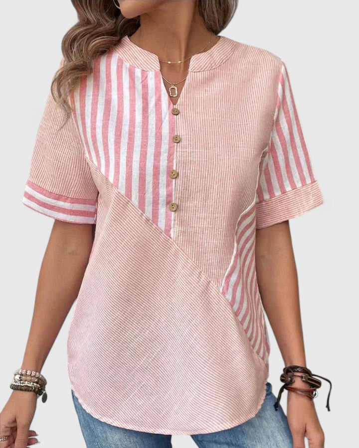 Isabel y Miguel Madrid Gigi sophisticated blouse in elegant fabric, shown in a close-up of the stylish, detailed design.
