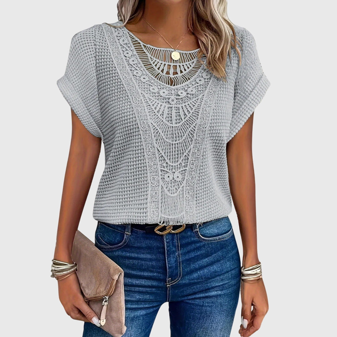 Isabel y Miguel Madrid Perla™ Ibiza style elegant blouse with flowing fabric and intricate embroidery.