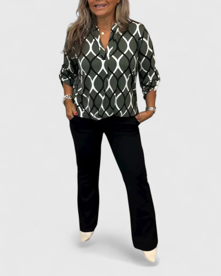 Elegant Isabel y Miguel Madrid Ella blouse with stylish design, featuring a sophisticated cut and fabric in a close-up view.