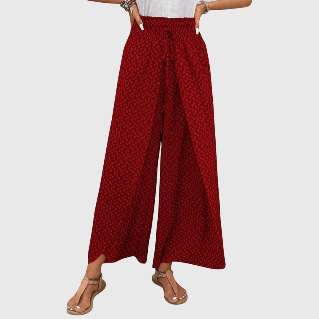 Pantalones Palazzo elegantes de Isabel y Miguel Madrid en color oscuro, con cintura de talle alto y tejido fluido.