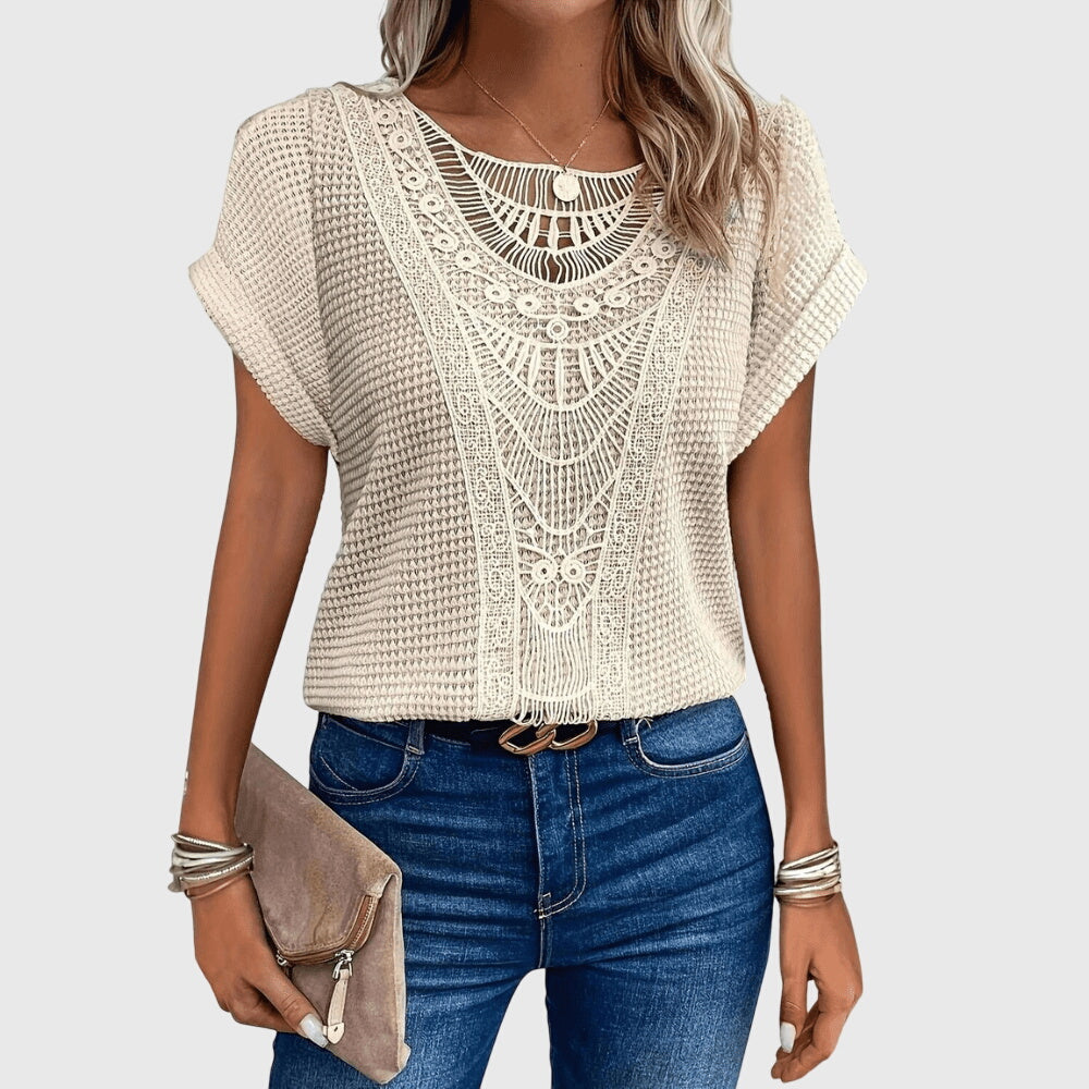 Perla™ Isabel y Miguel Madrid elegant Ibiza-style blouse with flowing fabric and intricate embroidery.