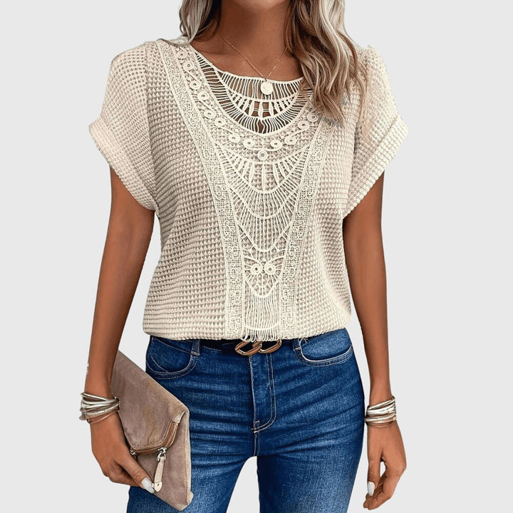 Perla™ Isabel y Miguel Madrid elegant Ibiza-style blouse with flowing fabric and intricate embroidery.