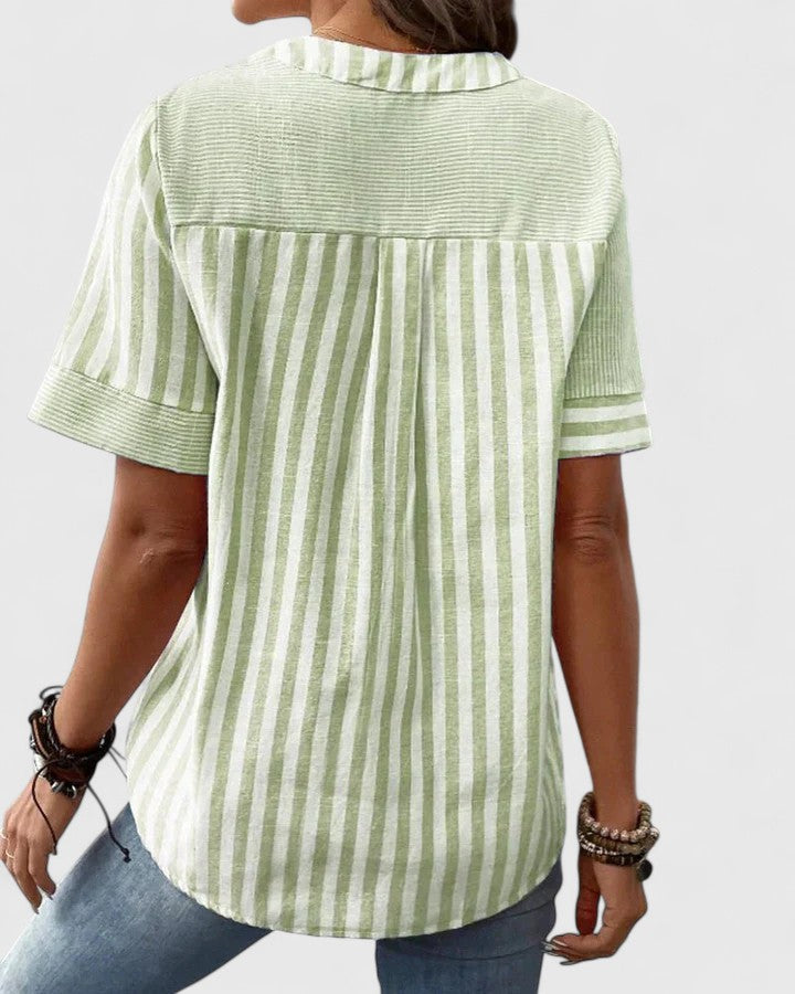 Isabel y Miguel Madrid Gigi sophisticated blouse with elegant design and lightweight fabric, worn by a model in a stylish setting.