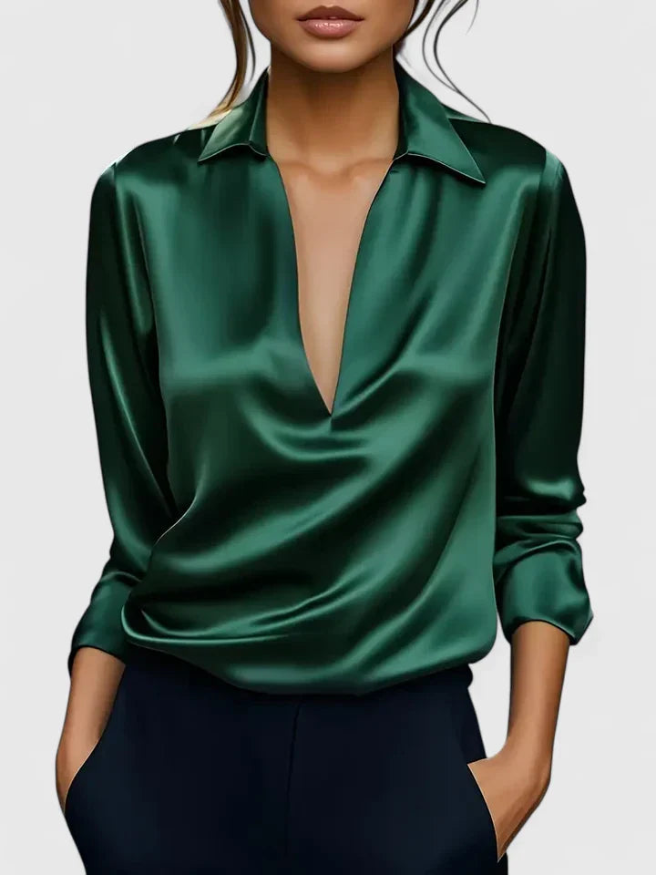 Elegant Isabel y Miguel Madrid Calvina blouse in black with a sophisticated design, featuring a stylish neckline and smooth fabric.