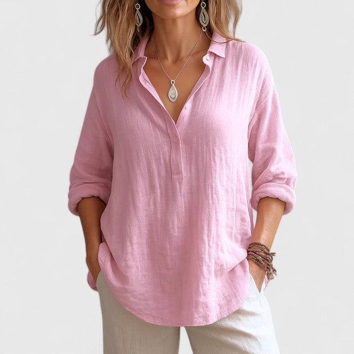Isabel y Miguel Madrid Franzina linen blouse with long sleeves and button-front design, displayed on a hanger.