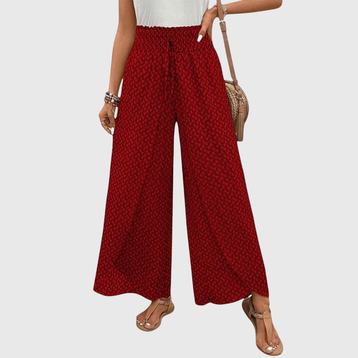 Pantalones palazzo elegantes Chiara de Isabel y Miguel Madrid en tela ligera y fluida, color negro, con cintura alta y corte amplio.