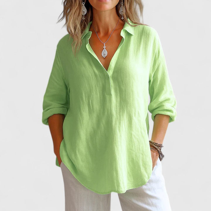 Isabel y Miguel Madrid Franzina linen blouse with relaxed fit, featuring a V-neck and long sleeves, displayed on a hanger.
