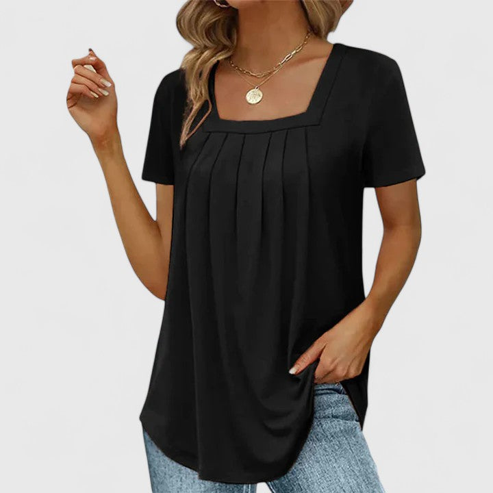 Lenabria summer blouse for women by Isabel y Miguel Madrid, lightweight and stylish, shown in a casual sunny setting.