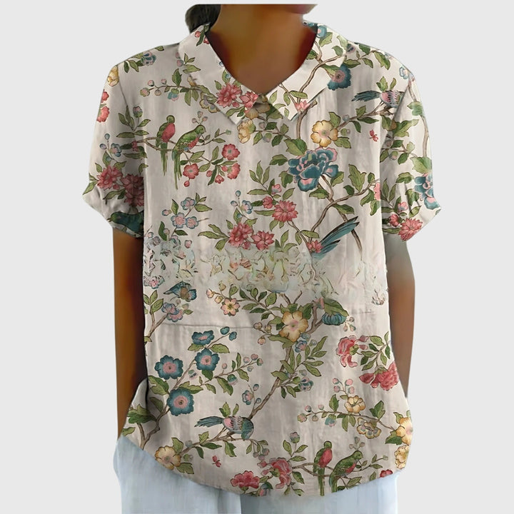 Isabel y Miguel Madrid Jenna™ floral blouse with colorful flower print and lightweight fabric, displayed on a mannequin.