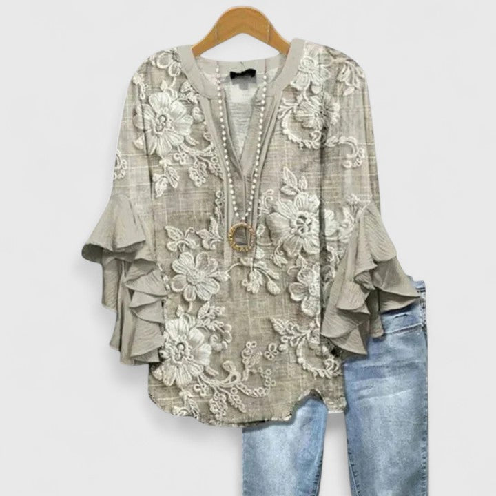 Isabel y Miguel Madrid Saryphiah comfortable blouse with relaxed fit, soft fabric, and stylish design, displayed on a hanger.