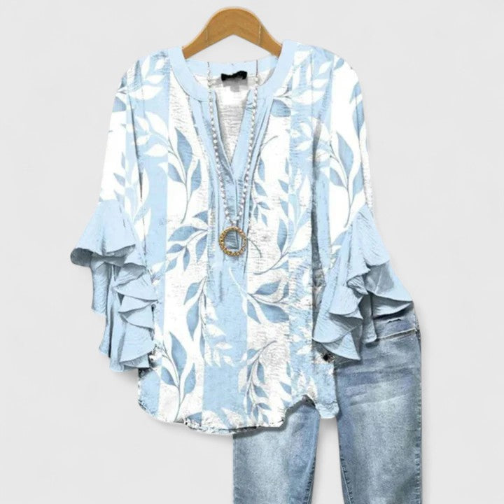 Elegant Isabel y Miguel Madrid Blusa by Taylisse featuring a stylish, flowing design and intricate details.