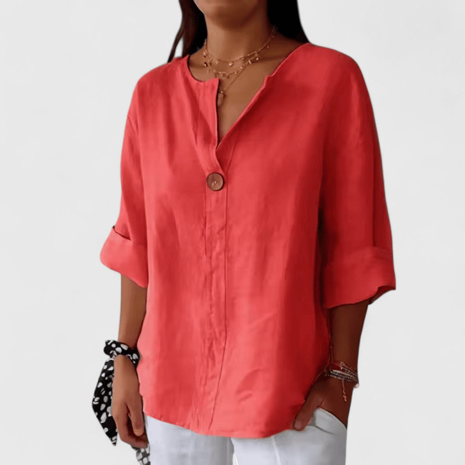 Elegant Isabel y Miguel Madrid Kianna blouse in black with stylish details, displayed on a hanger.