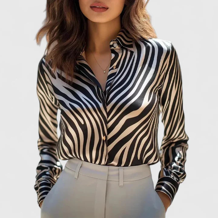 Elegant Lyzziane blouse by Isabel y Miguel Madrid, featuring a stylish design and premium fabric, displayed on a white background.