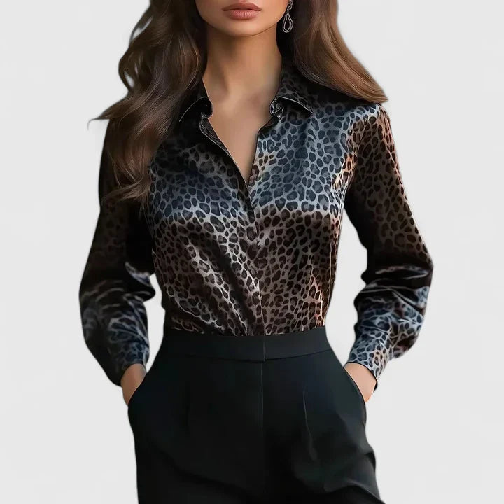 Elegant Lyzziane blouse by Isabel y Miguel Madrid, featuring a stylish design and luxurious fabric, displayed on a hanger.