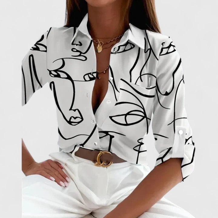 Elegant long-sleeve blouse from Isabel y Miguel Madrid featuring a classic design and soft fabric in neutral tones.