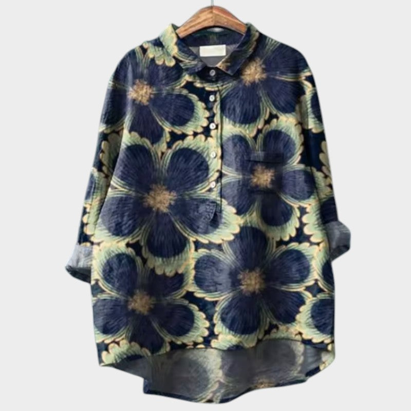 Light pink Isabel y Miguel Madrid Sia™ women's blouse with a relaxed fit and stylish collar, displayed on a hanger.