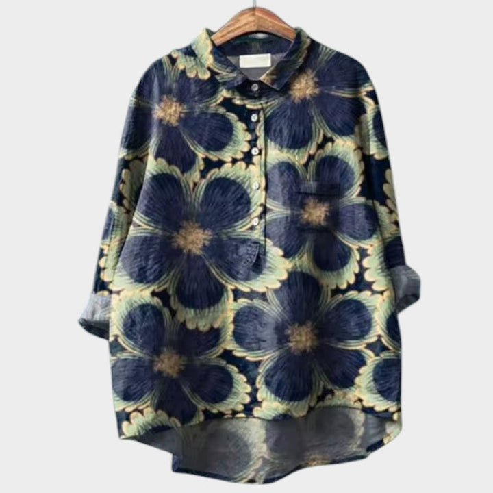 Light pink Isabel y Miguel Madrid Sia™ women's blouse with a relaxed fit and stylish collar, displayed on a hanger.