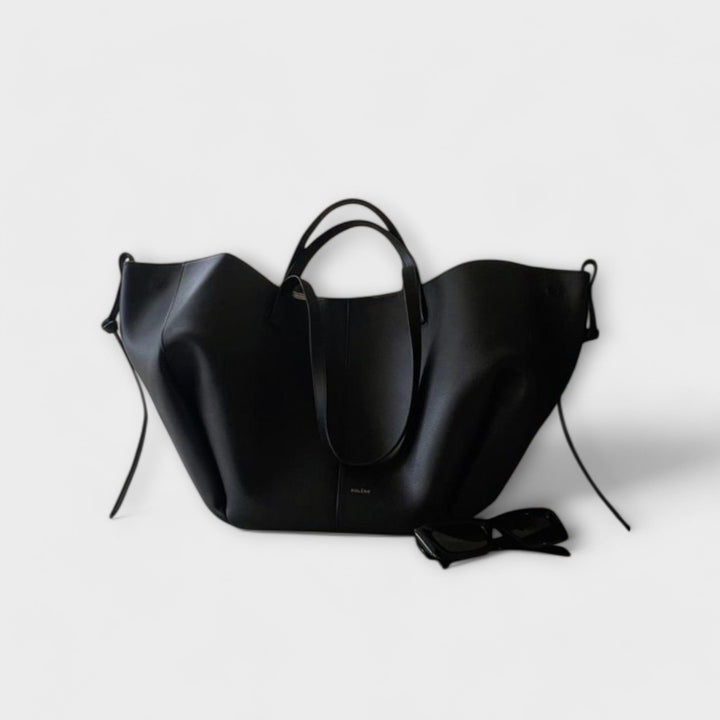 Black Olivia tote bag by Isabel y Miguel Madrid, vintage-style leather handbag with sturdy handles and spacious interior.