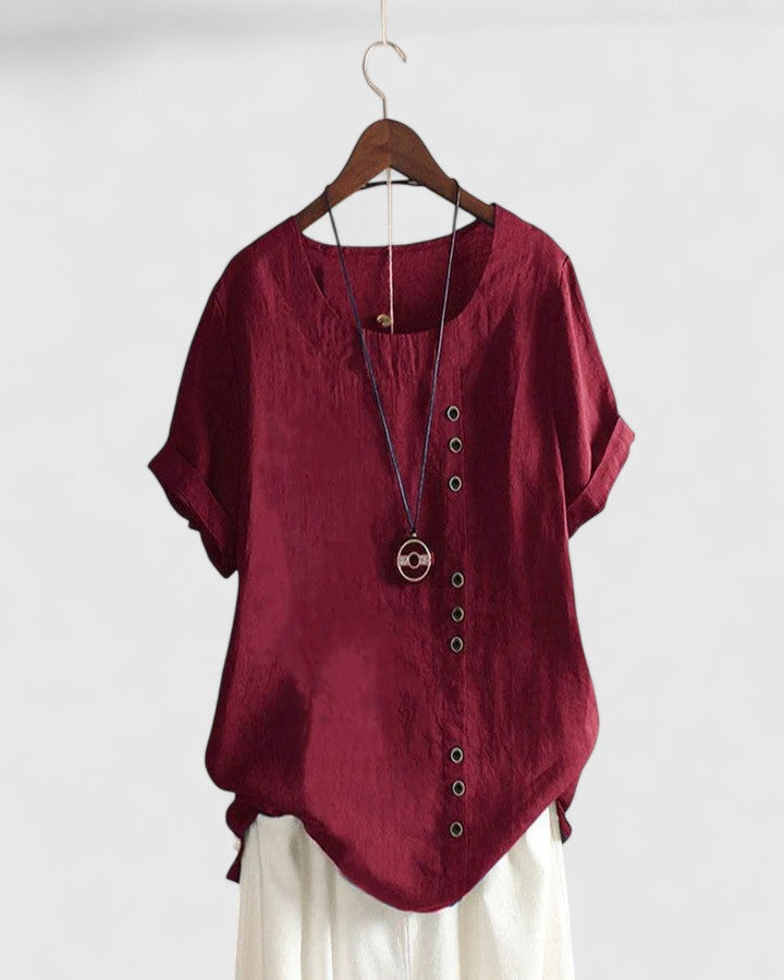 Bordeaux Elisavie women's short sleeve blouse from Isabel y Miguel Madrid, shown hanging with a relaxed fit and soft fabric.