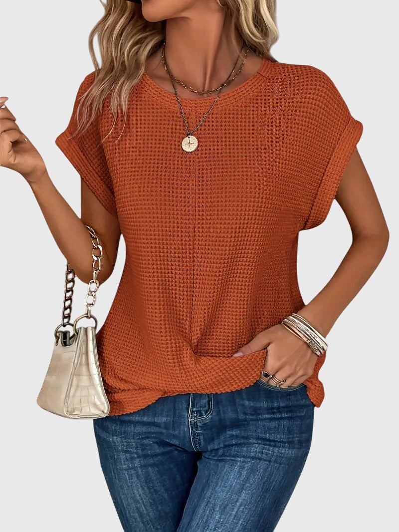 Isabel y Miguel Madrid Isa™ chic blouse with round neckline, soft fabric, and stylish design, shown on a hanger.