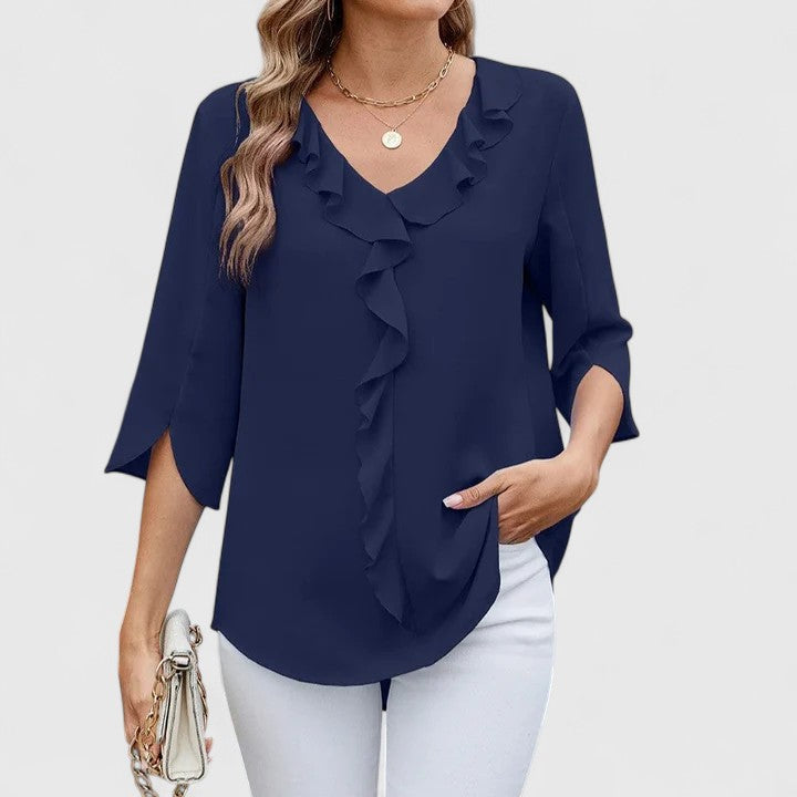 Elegant Debby blouse by Isabel y Miguel Madrid, featuring stylish design and lightweight fabric, displayed on a hanger.