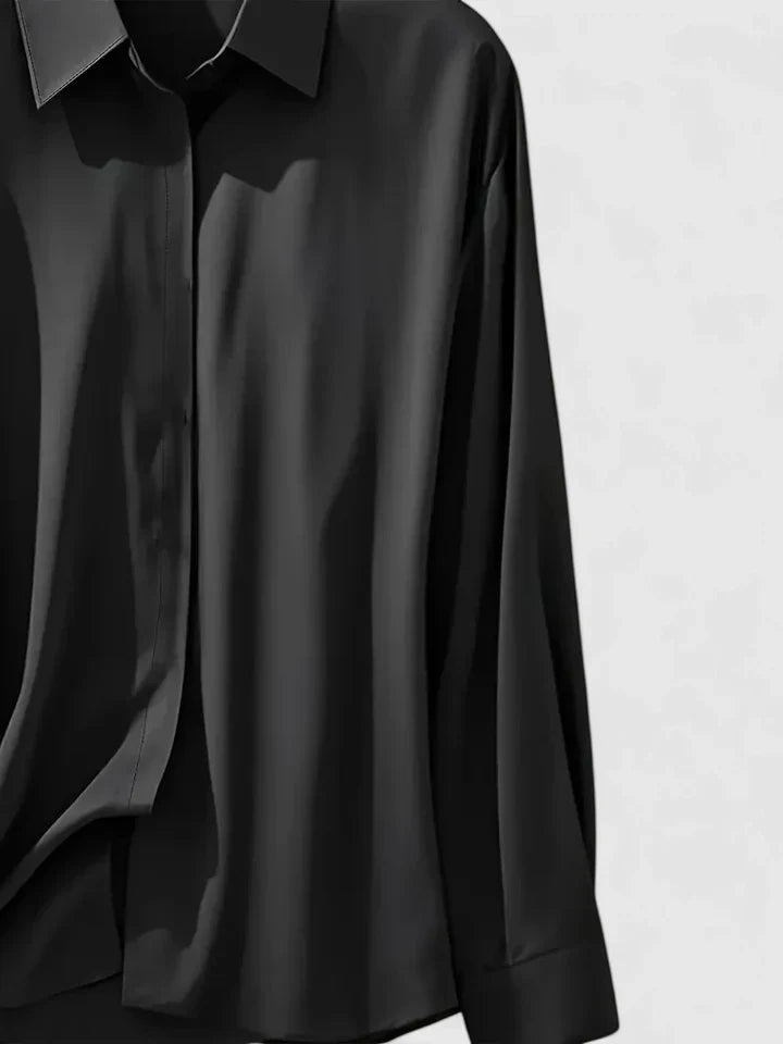 Elegant Isabel y Miguel Madrid Melvaya top in soft fabric, featuring a stylish neckline and tailored fit, displayed on a neutral background.